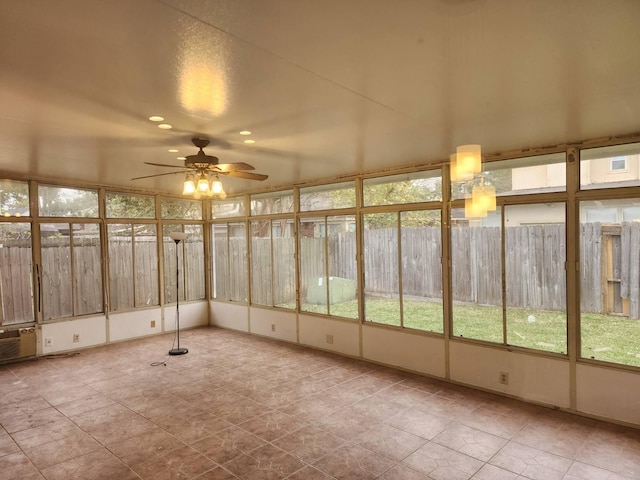 unfurnished sunroom featuring ceiling fan