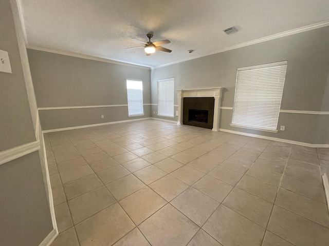 unfurnished living room featuring ceiling fan, light tile patterned floors, and ornamental molding