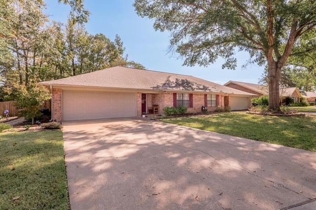 single story home with a garage and a front lawn