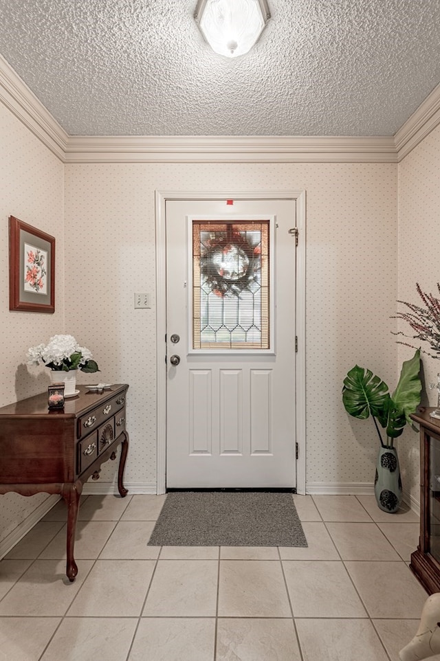 entrance foyer with ornamental molding, a textured ceiling, and light tile patterned floors