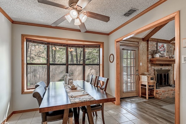 dining room with plenty of natural light, light hardwood / wood-style floors, a textured ceiling, and ceiling fan