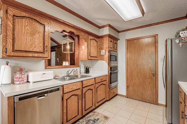 kitchen with sink, stainless steel appliances, a textured ceiling, and ornamental molding