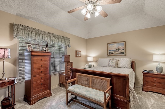 bedroom with a textured ceiling, ceiling fan, lofted ceiling, and light carpet