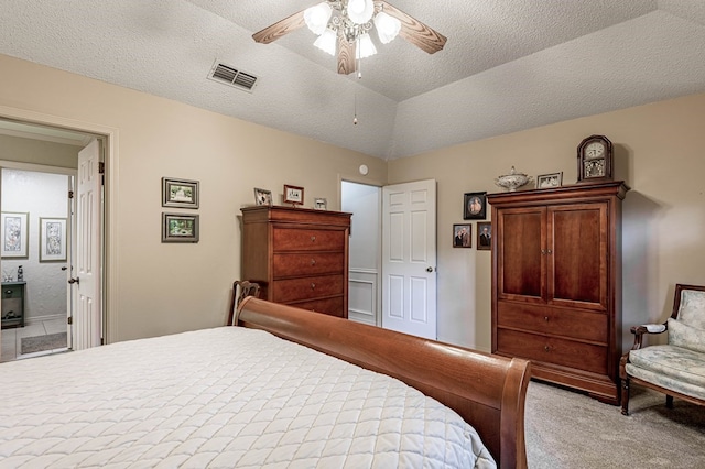 bedroom featuring ensuite bath, vaulted ceiling, ceiling fan, a textured ceiling, and light colored carpet