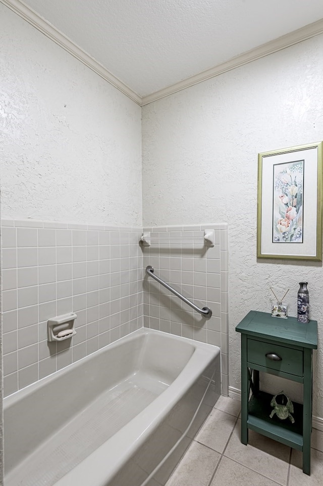 bathroom featuring tile patterned flooring, a bathtub, and a textured ceiling