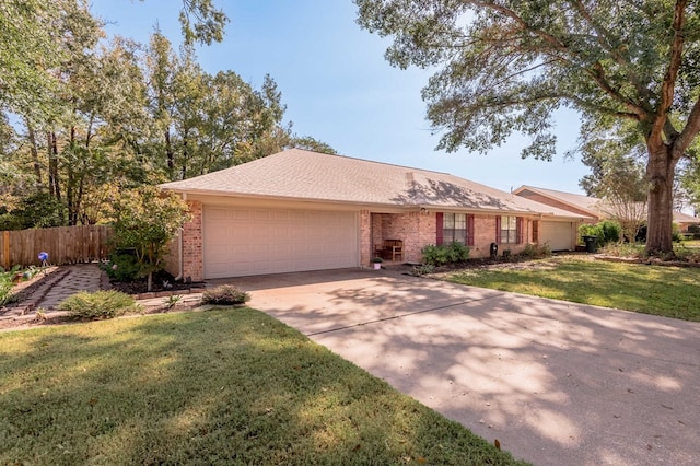 ranch-style house featuring a garage and a front lawn