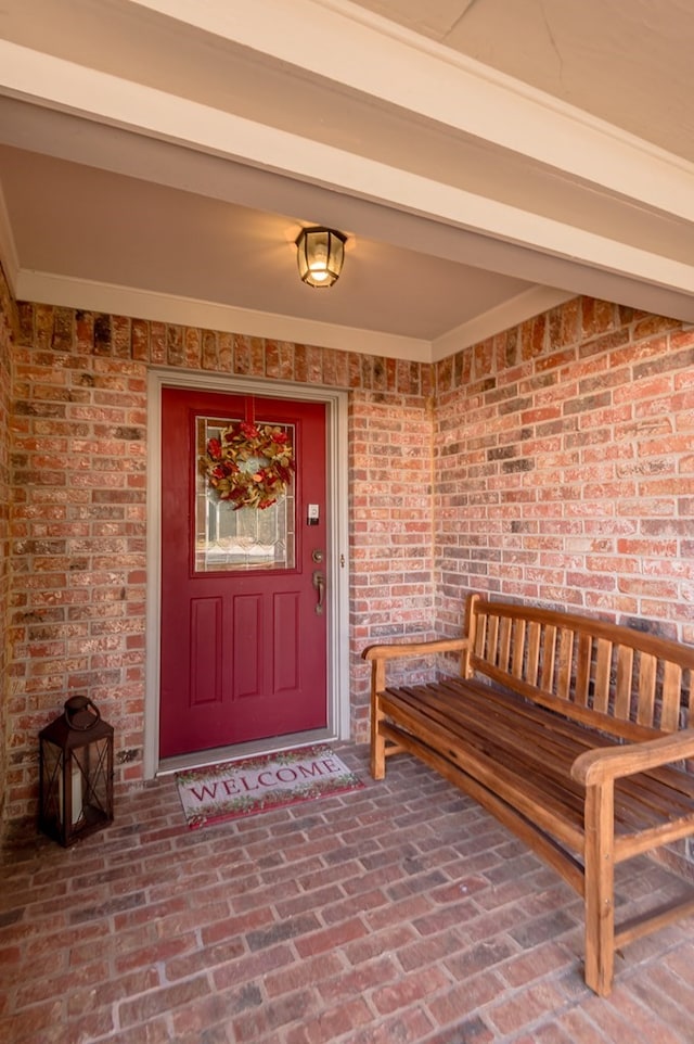 view of exterior entry with a porch