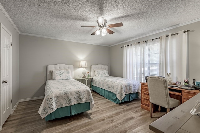 bedroom with hardwood / wood-style flooring, ceiling fan, ornamental molding, and a textured ceiling