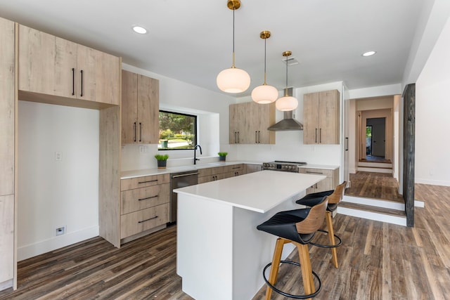 kitchen with a center island, dark hardwood / wood-style flooring, decorative light fixtures, light brown cabinetry, and appliances with stainless steel finishes