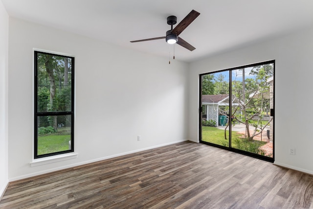 empty room featuring ceiling fan and hardwood / wood-style floors