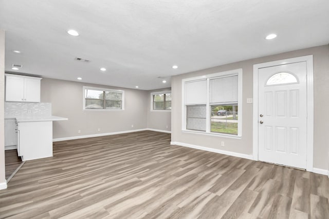 unfurnished living room with light hardwood / wood-style flooring