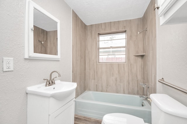 full bathroom with washtub / shower combination, vanity, a textured ceiling, and toilet