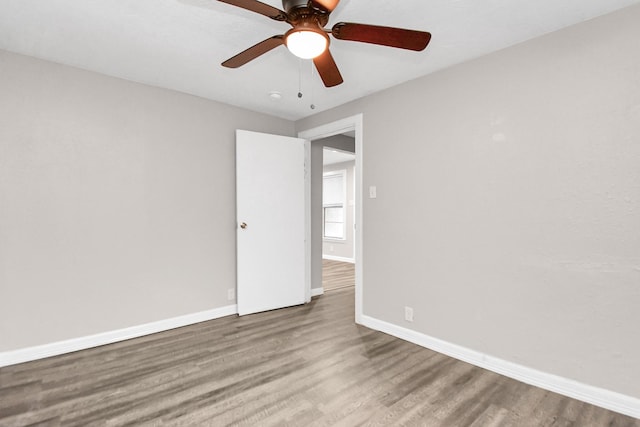 spare room with hardwood / wood-style flooring and ceiling fan