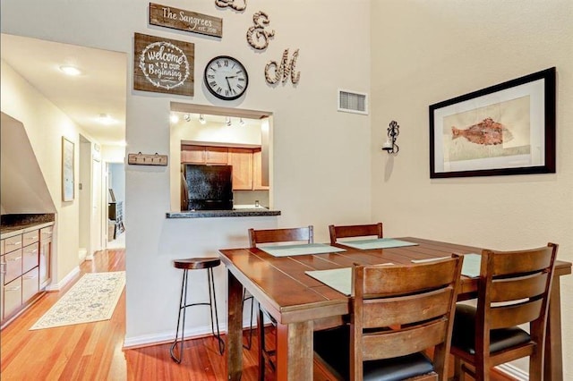 dining space with light hardwood / wood-style flooring