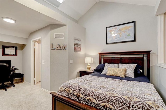 carpeted bedroom with lofted ceiling