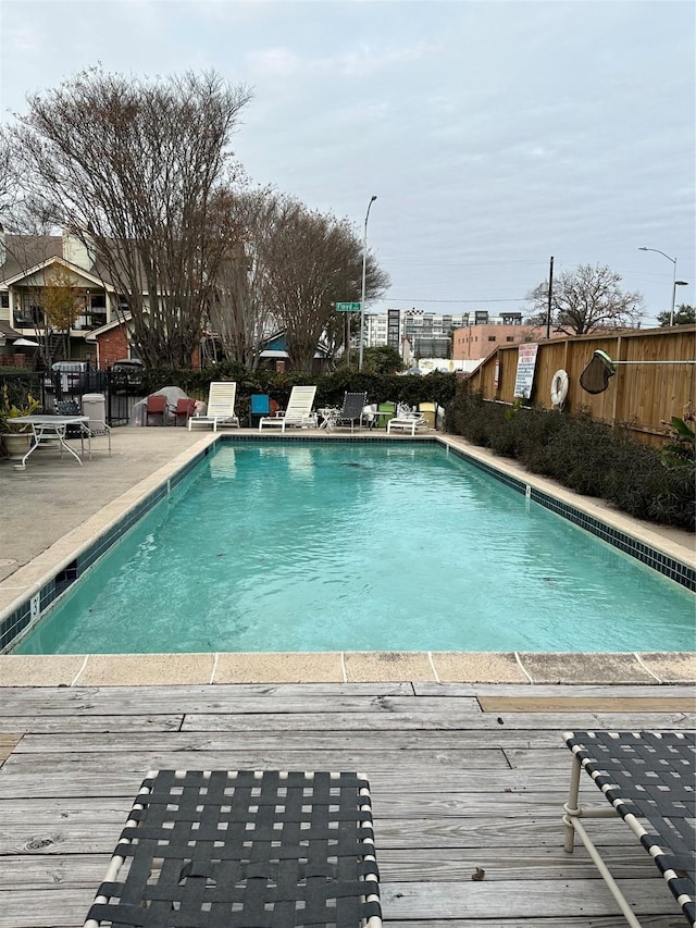 view of swimming pool with a deck