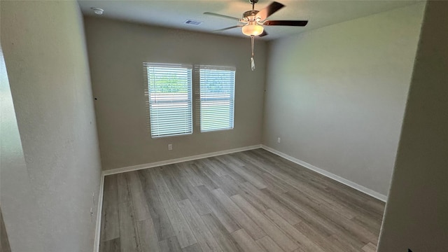 2925 Terrace Grove Dr, Conroe, TX 77304 - empty room featuring ceiling fan, wood finished floors, and a smoke detector