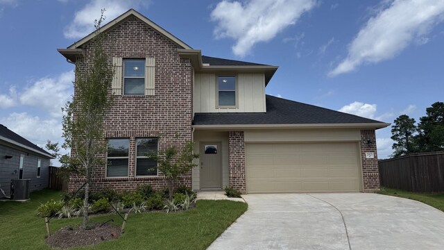 2925 Terrace Grove Dr, Conroe, TX 77304 - traditional-style house featuring brick siding, driveway, a garage, and board and batten siding