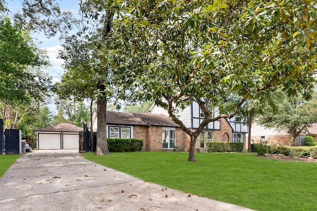 view of front of property with a front yard, an outbuilding, and a garage