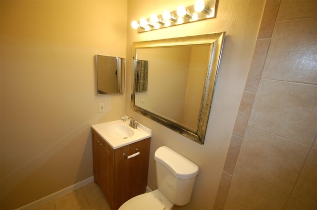 bathroom featuring tile patterned flooring, vanity, and toilet