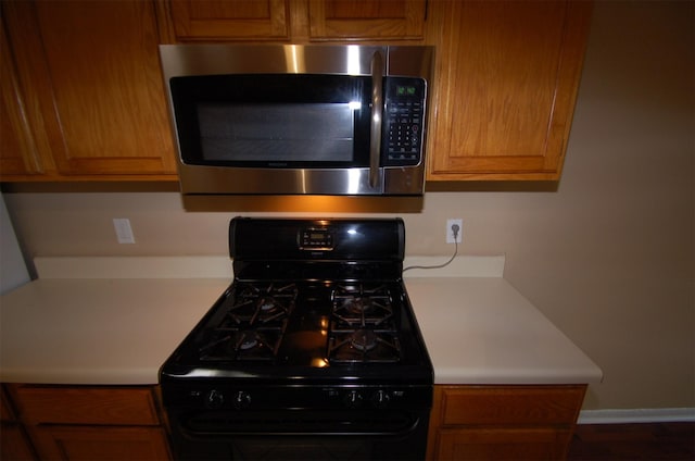 kitchen with black gas range oven