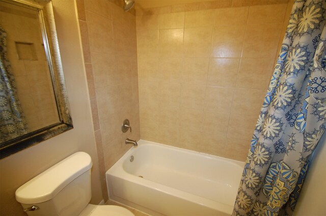 bathroom with shower / tub combo and toilet