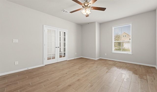 spare room with ceiling fan, light wood-type flooring, and french doors