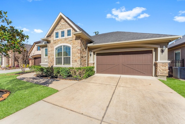 craftsman-style house featuring a garage and central air condition unit