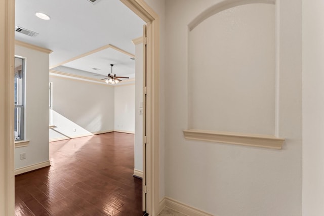 hallway featuring dark hardwood / wood-style floors and crown molding