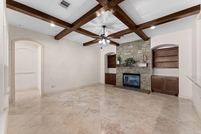 unfurnished living room with beamed ceiling, a fireplace, and coffered ceiling