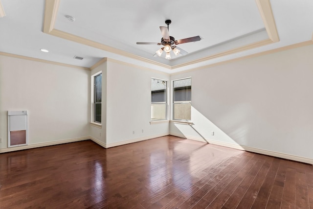 empty room featuring hardwood / wood-style floors, ceiling fan, and a raised ceiling