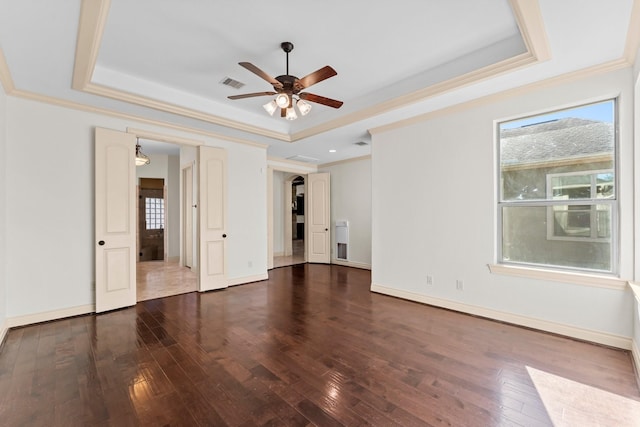 spare room featuring a tray ceiling, a wealth of natural light, and ceiling fan