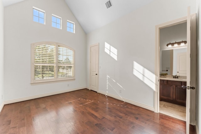 foyer entrance with sink, high vaulted ceiling, and dark hardwood / wood-style floors