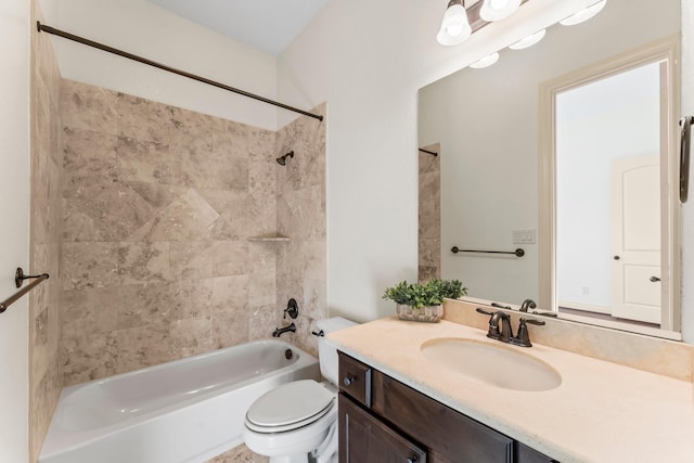 full bathroom featuring tiled shower / bath combo, toilet, and vanity