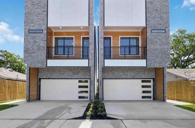 contemporary home with a garage and a balcony