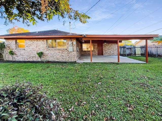 rear view of house with a patio area and a yard