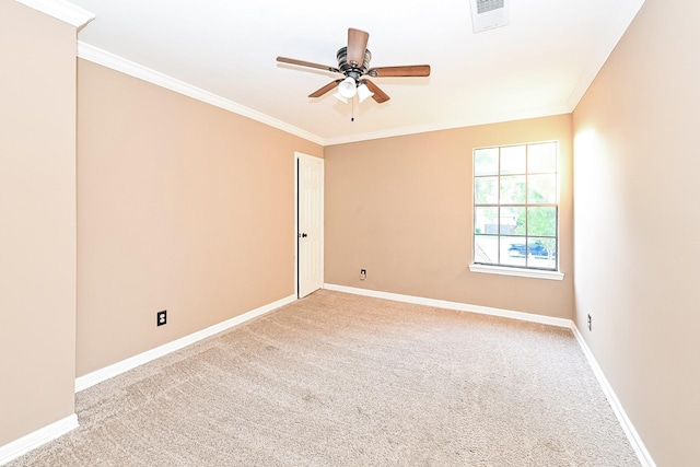 carpeted empty room with ceiling fan and crown molding