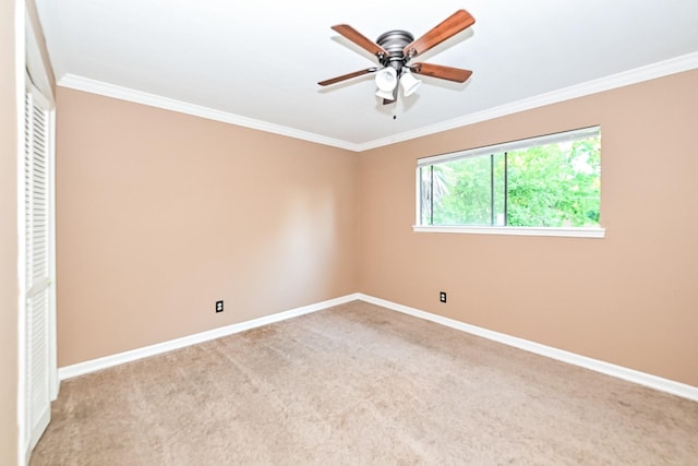 unfurnished bedroom with ceiling fan, ornamental molding, and light carpet