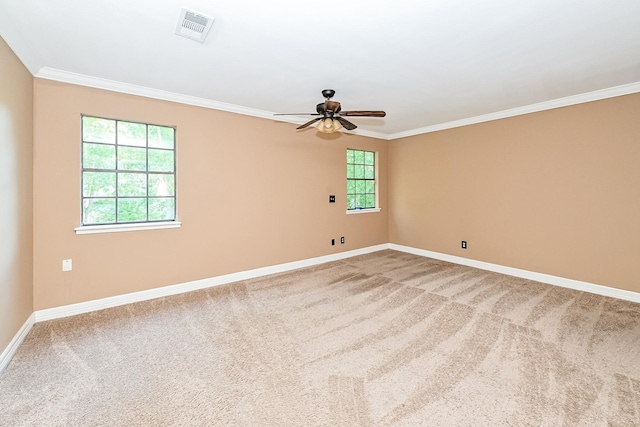 carpeted empty room with crown molding, ceiling fan, and a healthy amount of sunlight