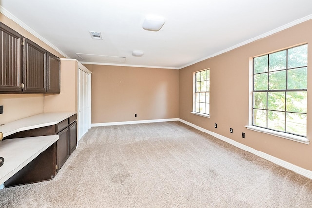 unfurnished living room featuring light colored carpet and ornamental molding