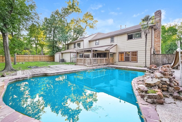 view of pool with a yard and a water slide