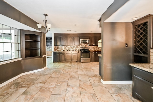 kitchen with dark brown cabinetry, hanging light fixtures, an inviting chandelier, backsplash, and appliances with stainless steel finishes