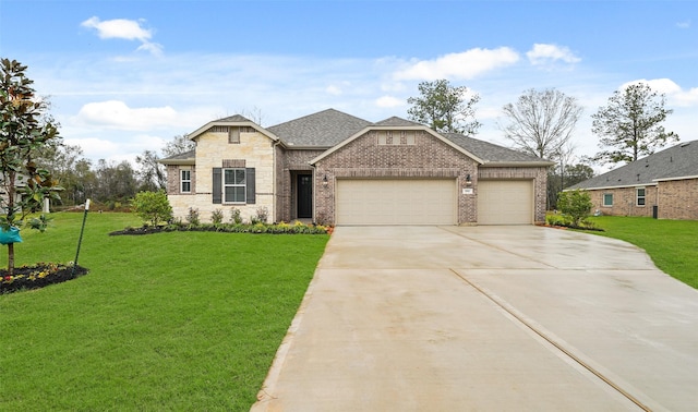 view of front of house with a garage and a front lawn