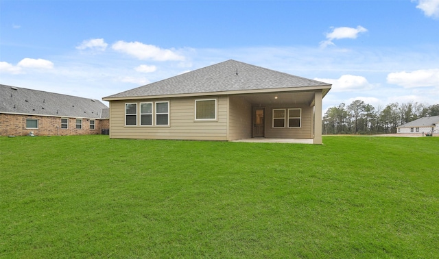 back of house with a yard and a patio area