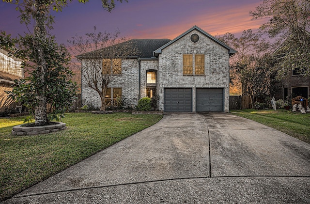 view of front of home with a lawn and a garage