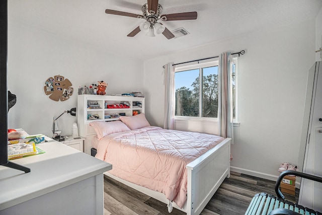 bedroom featuring dark hardwood / wood-style flooring and ceiling fan