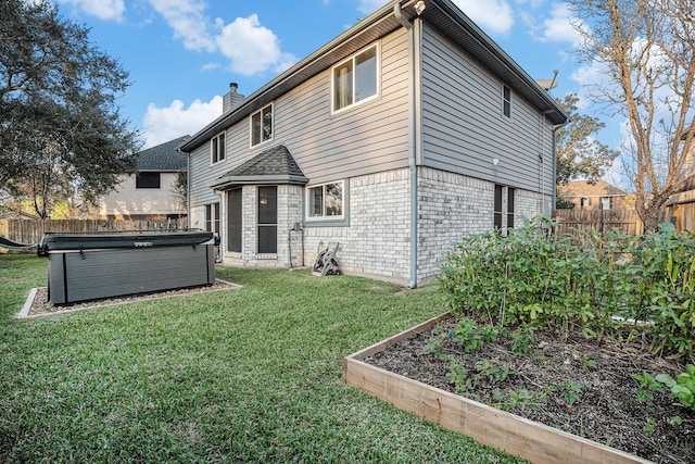 rear view of house featuring a lawn