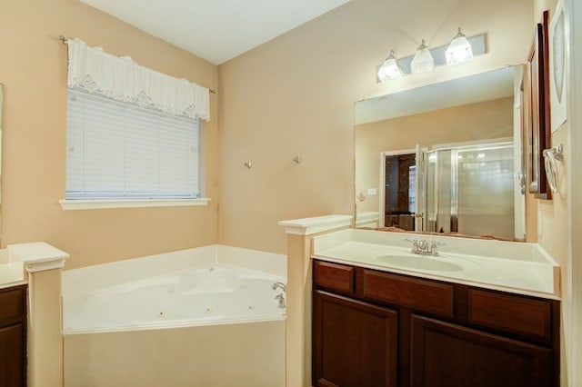 bathroom featuring vanity and shower with separate bathtub