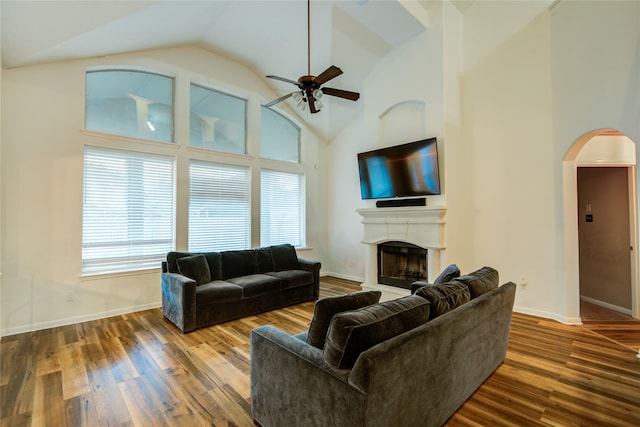 living room featuring wood-type flooring, high vaulted ceiling, and ceiling fan