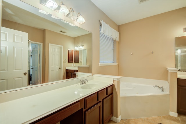 bathroom featuring tile patterned floors, a washtub, and vanity